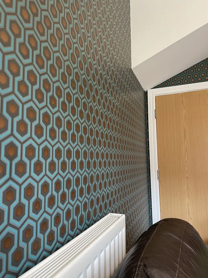 Entrance stairwell with finished wallpaper and painted trim