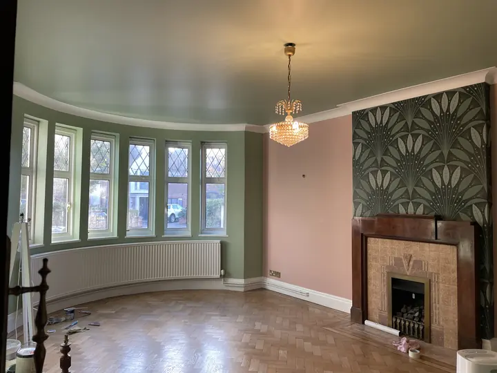Highgate reception room with soft green walls and botanical wallpaper chimney breast