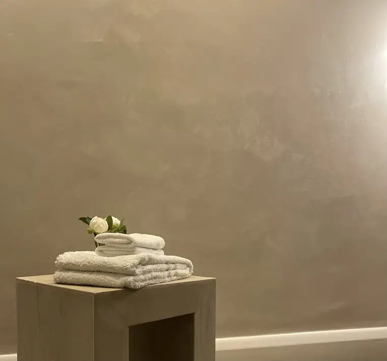 Limewashed wall with soft mottled movement in warm natural light